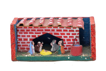 a little house as Christmas decoration on white background, a handmade box with nativity scene...