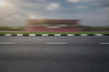 empty asphalt road with speedy f1 background, speeding highway roadside stadium building  © redtiger9