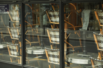 Rattan chairs stacked outside a bistro in paris, France