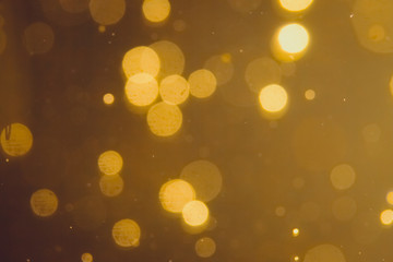 Dark Abstract Gold bokeh sparkle on black background