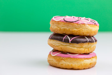 Colorful donuts stacked isolated on white