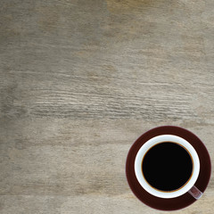 Coffee cup on wooden rustic background. Top view with morning sunlight