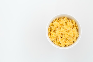 bowl of dry pasta isolated on a white background with copy space