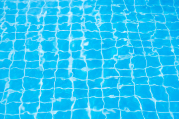 Reflections from the water in the blue swimming pool