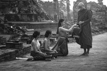 Offering alms to monks Is the merit of Buddhism On Lent Day at one of the old temples In Phra Nakhon Si Ayutthaya province, Thailand