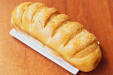 Baked breads on wooden table background.