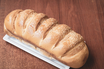 Baked breads on wooden table background.