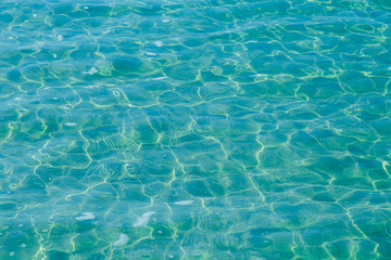 Blue pool water with sun reflections