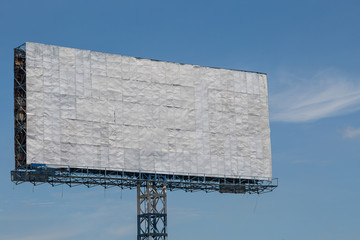 White billboard with blue sky and clouds