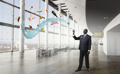 Conceptual image of ambitious and creative businessman in black suit holding paintbrush in hand