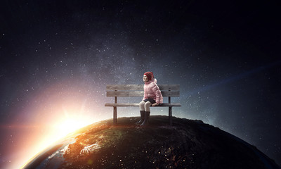 Dreamy little girl sitting ready for adventure