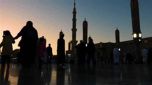 Medina, Saudi Arabia &ndash; MARCH 20, 2019: Timelapse of Pilgrims walking outside of Nabawi Mosque,Medina during sunset.