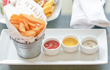 french fried bar with dipping ketchup with bucket