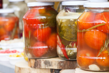 Fototapeta na wymiar Marinated tomatoes in glass jar. Healthy snack