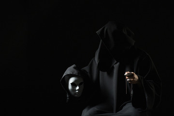 Rite of deal with devil. Sinner in black clothes and demon in sleeve. Man possessed by devil. Evil...