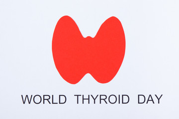 Red thyroid shape and inscription World Thyroid Day. Problems with thyroid concept