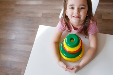 the child collects a pyramid. Details of the toy in the hands. Concept of development of fine motor skills, educational games, childhood, IVF, children's day, kindergarten copy space