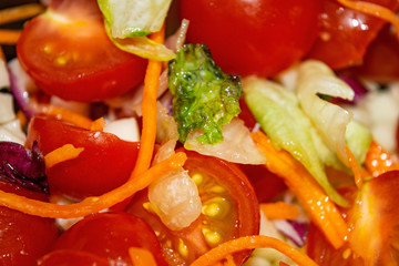 Vegetable salad sliced tomatoes, onions, lettuce, carrots and beets. Close up. Healthy food and fitness diet.