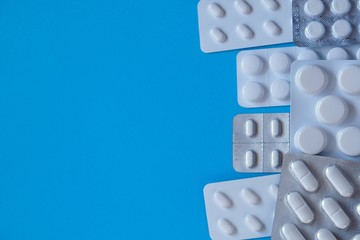 Pills packing. Pills set on a blue background.Health and medicine concept.Medicinal drug.Cold and flu.Treatment and prevention of viral diseases.copy space.Medication and prescription pills. 