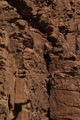 Entrance to the Wadi Mujib canyon in Jordan. Steep rocks and a rapid flowing river carved. Difficult crossing and attraction for tourists on the water route.