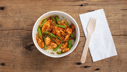 Stir fried chicken with vegetable asian street  food in food paper box, top view