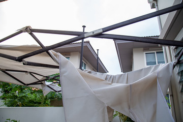 The canvas tent is torn because of a storm.