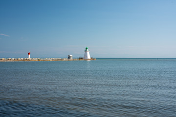 Beautiful Waterfront Landscape during clear blue skies with a lighthouse 