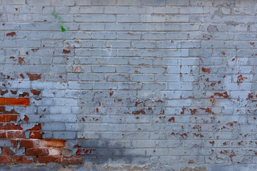 old grungy white brick wall with graffiti 