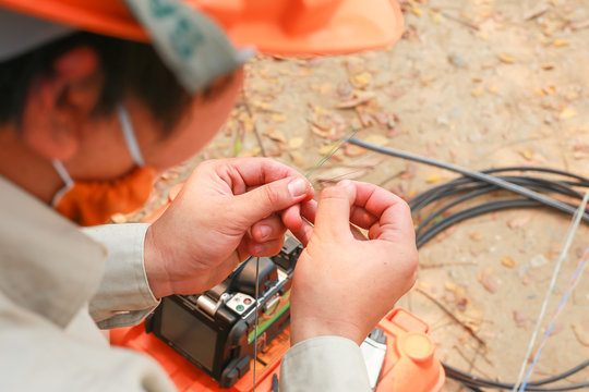 The Technician Is Connecting The Fiber Optic Cable 