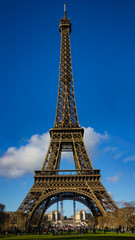 Fototapeta na wymiar Eiffel Tower on a sunny day and blue sky