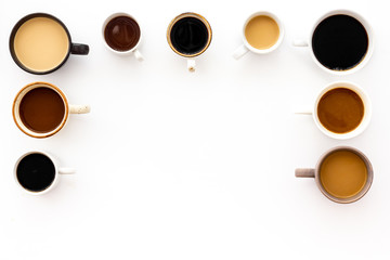 Cups of hot drinks on white background from above frame copy space