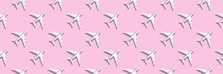 Creative banner of white planes on pink background. Travel, vacation concept. Travel, vacation ban. Flights cancelled and resumed again. Top view. Flat lay. Minimal style design. Summer pattern.