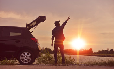 Man travel on road trip in summer with car parked on road
