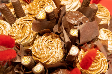 Decorative confectionery bouquet of chocolate, marshmallows, marmalade and marshmallows.
