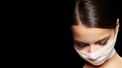 Beautiful woman with bandage mask on face. Fashion eye make-up. Beauty surgery or protection...