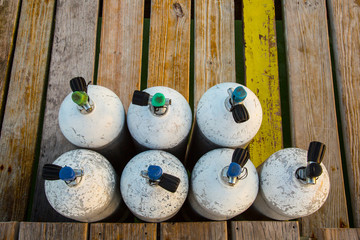 Scuba Tanks on wood dock ready for divers