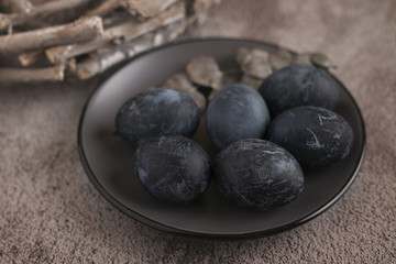 Painted dark blue eggs on a plate