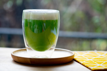 Iced green tea with milk foam.