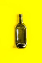 Wine bottle on yellow background top view