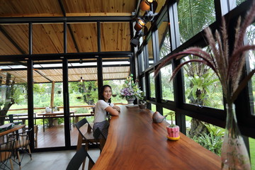Obraz na płótnie Canvas Woman sitting in a cafe in Chon Buri, Thailand
