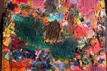 Artist's palette with oil paints, abstract background