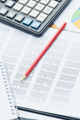 Business financial documents, office calculator and pen on the table. Numbers and graphs