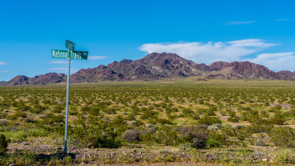 Route 66 landscape in Mojave desert with national Trails sign post. 