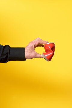 Hand Crushing A Can Of Drink