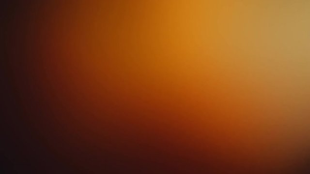 Warm color motion gradient background with seamless loop repeating. Abstract orange color light background animation with smooth blurred gradient.