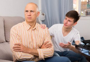 Fototapeta premium Son apologizing to father