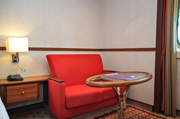 Living room area inside balcony cabin or veranda suite onboard Hurtigruten expedition cruiseship or...
