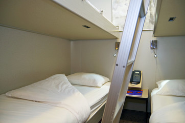 Interior stateroom or inside cabin on modern cruiseship or cruise ship liner with bunk beds
