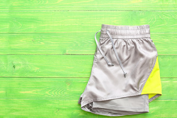Sportswear on color wooden background