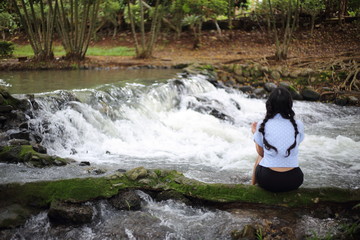 Woman and Nam Tum waterfall in Chanthaburi at thailand	